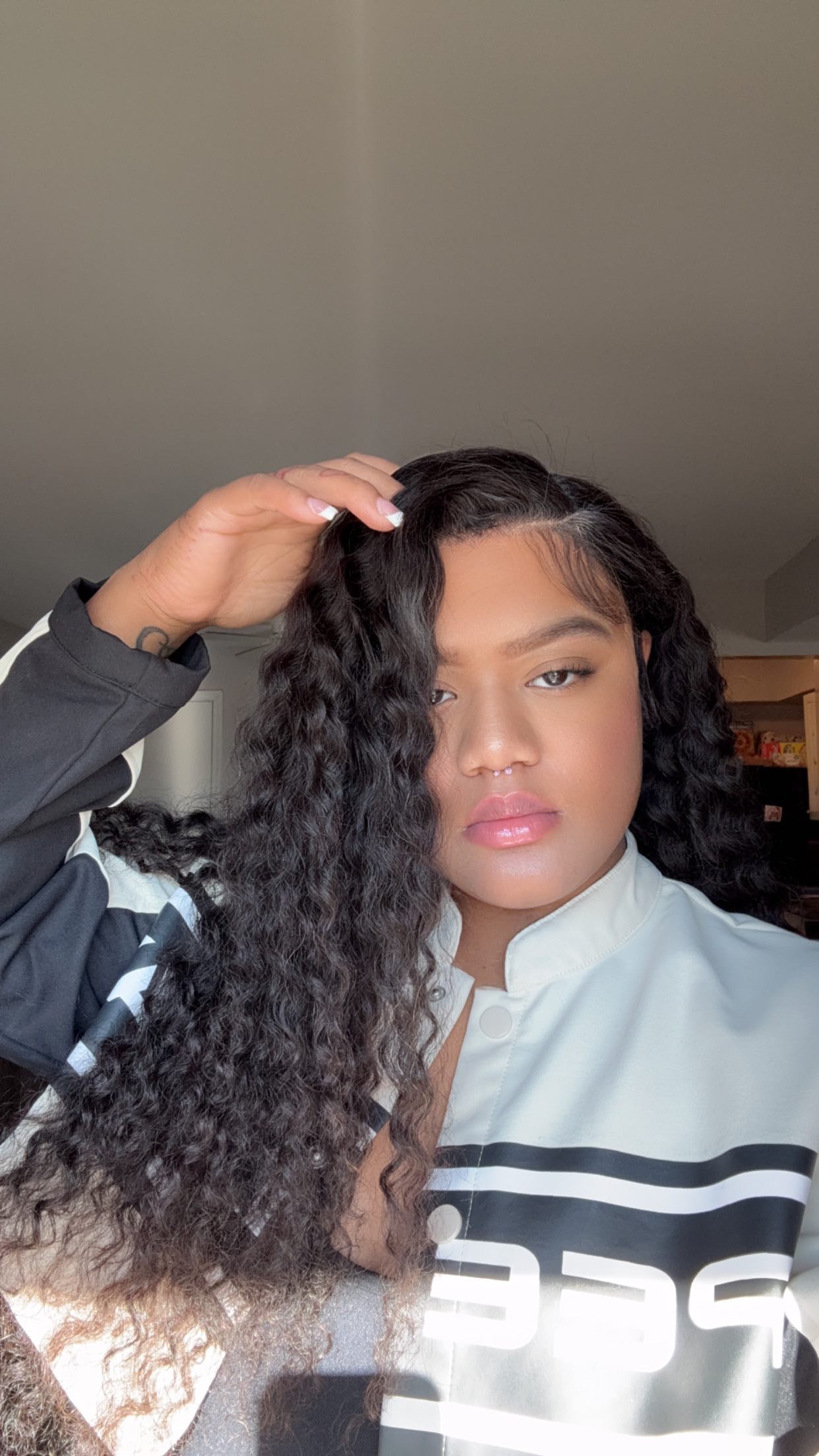 Girl wearing 26 inch Deepwave HD Lace wig with side part also wearing black and white jacket