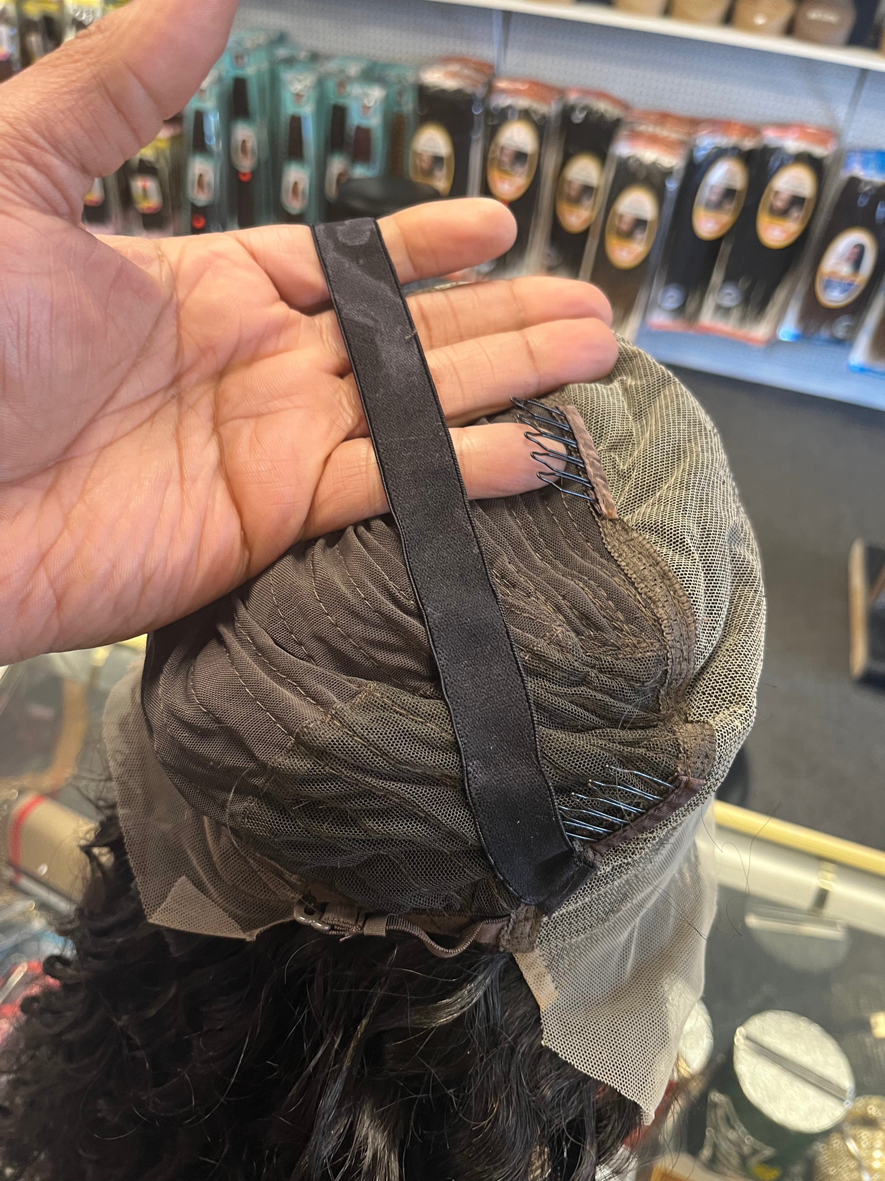 Glueless 13 by 4 Frontal Bodywave Lacewig 30 inches on Mannequin turned inside out showing cap design sitting on glass showcase with grey background
