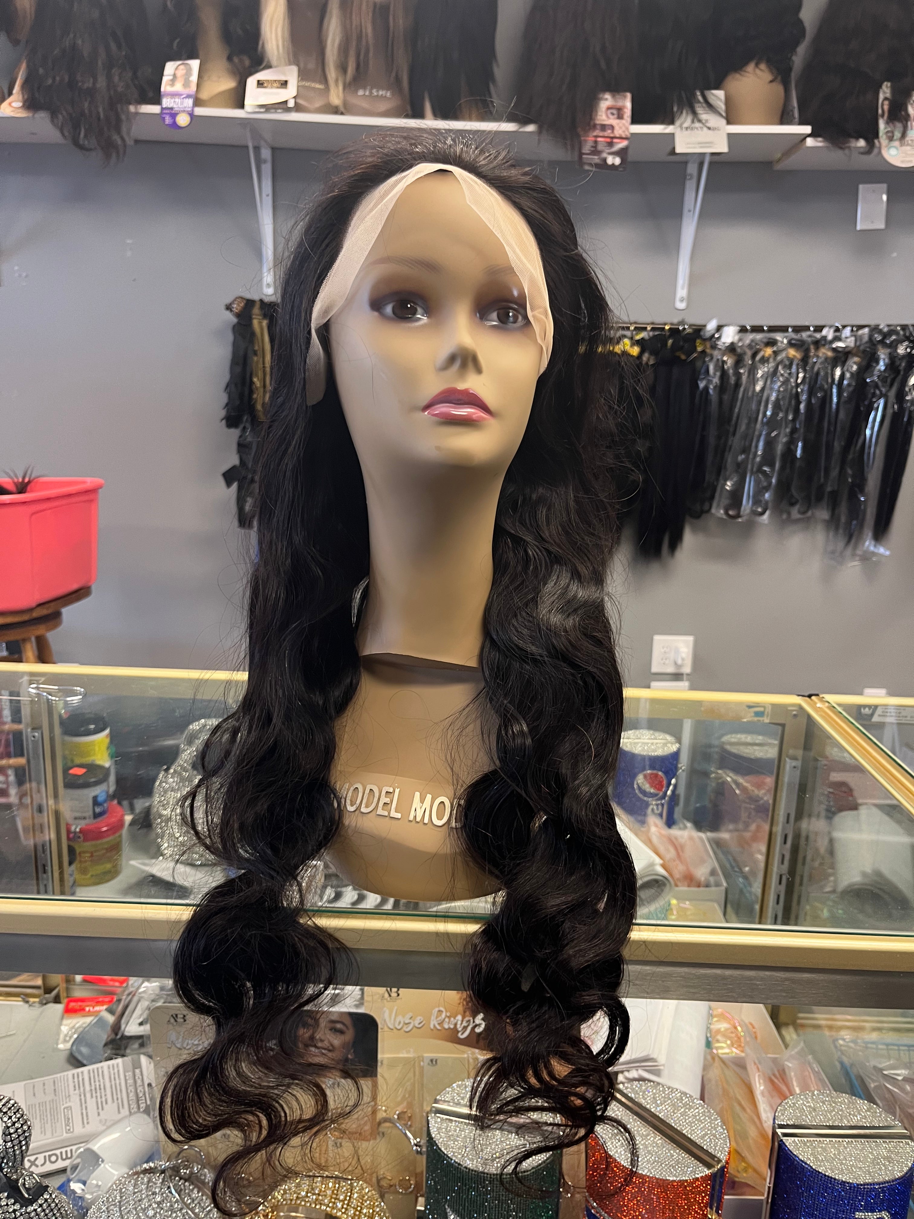 Glueless 13 by 4 Frontal Bodywave Lacewig 30 inches on Mannequin sitting on glass showcase with grey background