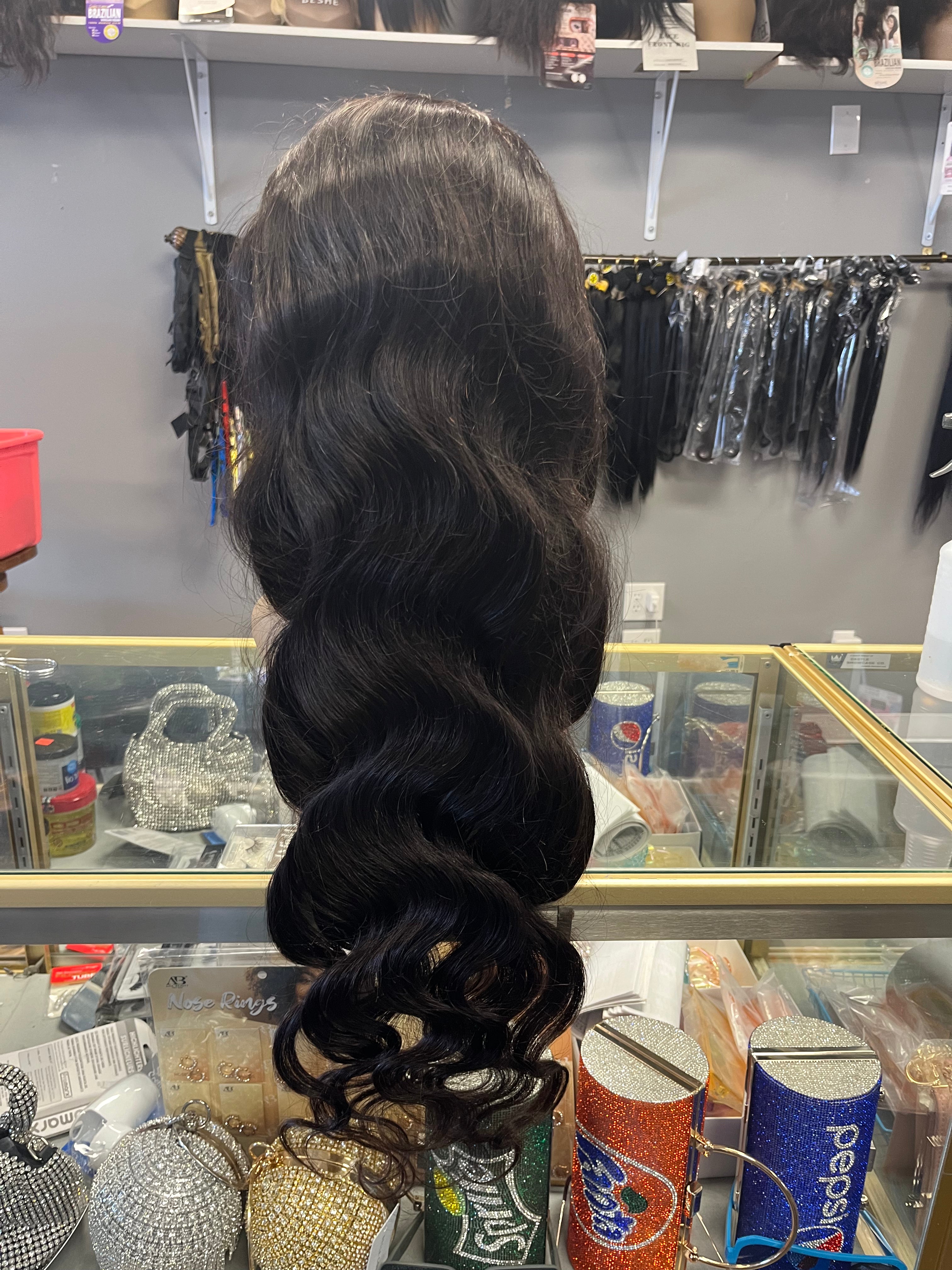 Glueless 13 by 4 Frontal Bodywave Lacewig 30 inches on Mannequin sitting on glass showcase with grey background