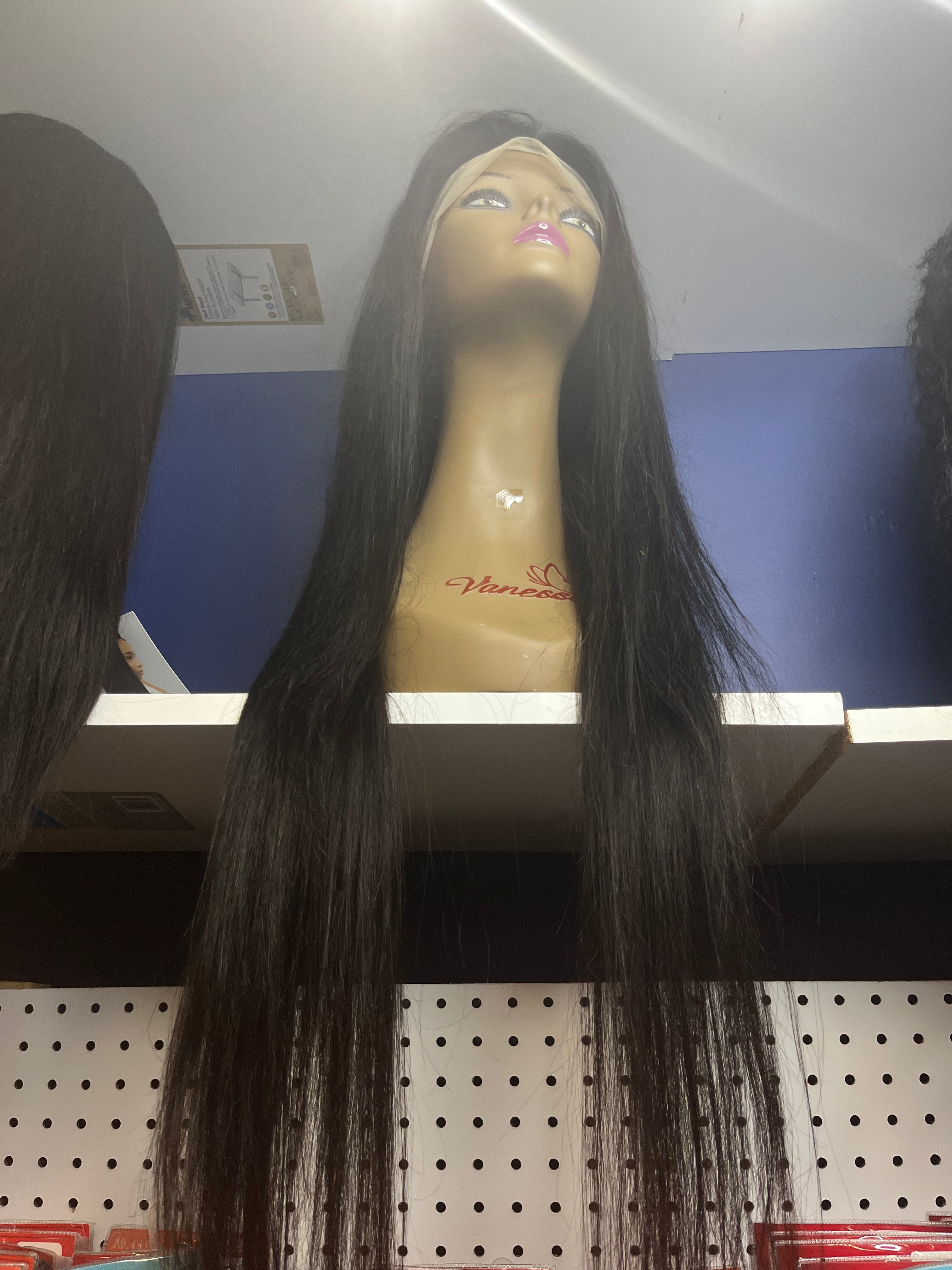 13 by 4 virgin hair straight glueless HD lace wig 30 inches preplucked on a mannequin sitting on a white shelf with a blue background