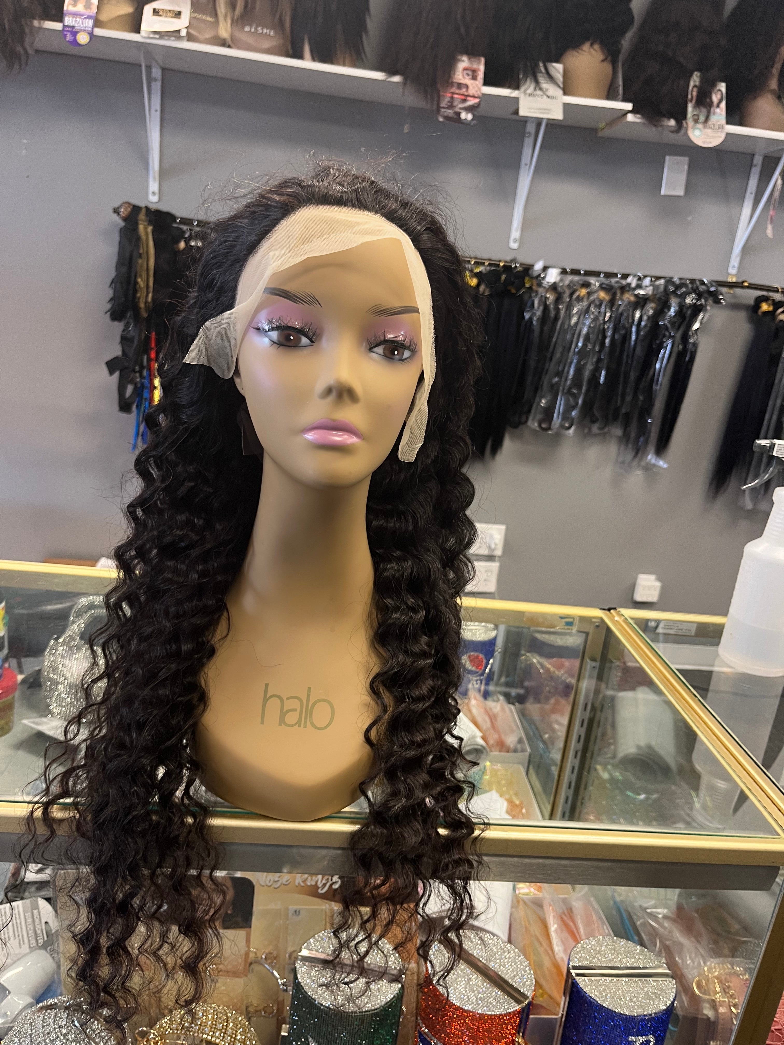 Glueless 13 by 4 Frontal Deep Wave Lacewig on Mannequin sitting on glass showcase