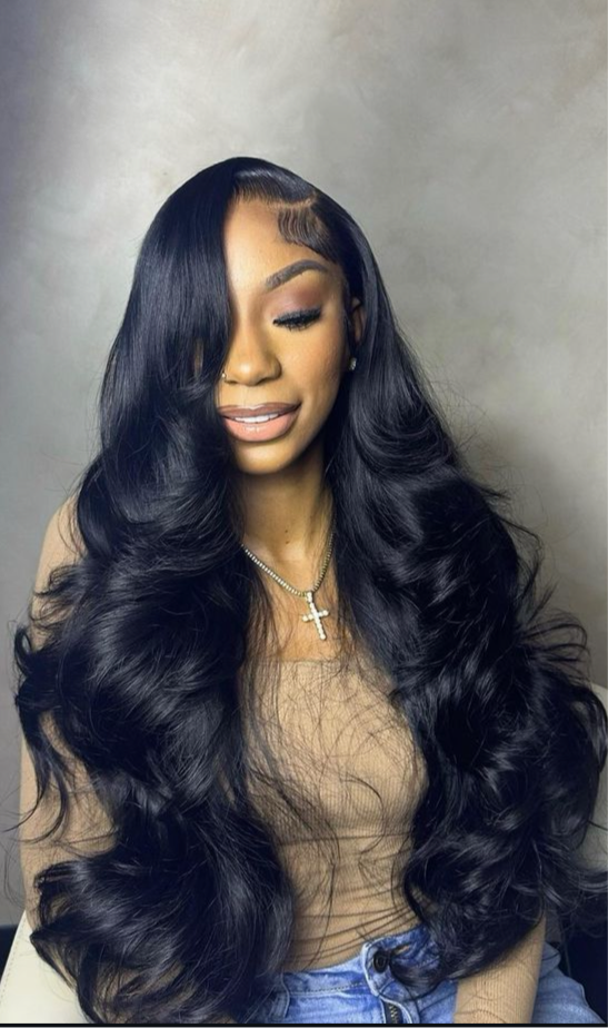 13 by 4 virgin hair Glueless Lace wig 30 inches worn by a beautiful woman with a tan shirt and grey background 